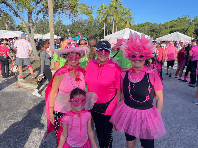 Community members spreading breast cancer awareness at a local event